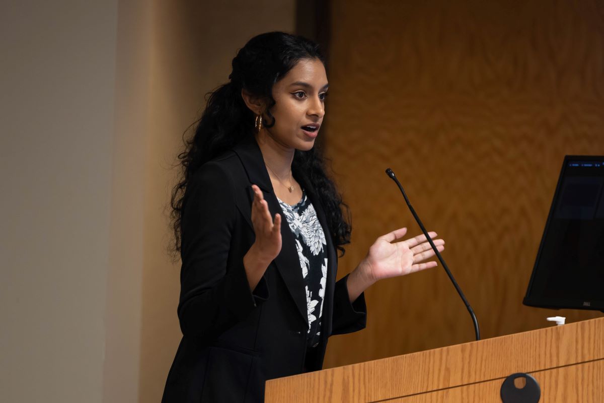 Female presenter standing at the podium at the 2023 SOPH Research Day